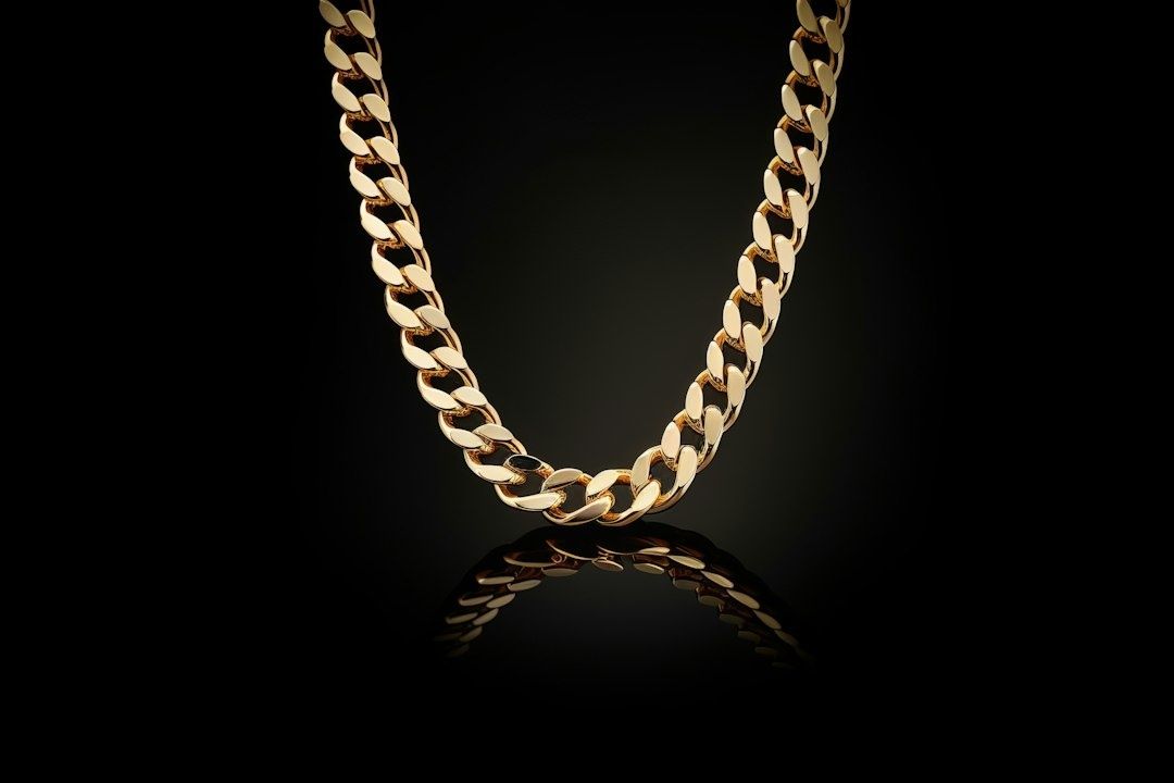 Gyllene Bismarckhalsband mot svart bakgrund med spegling